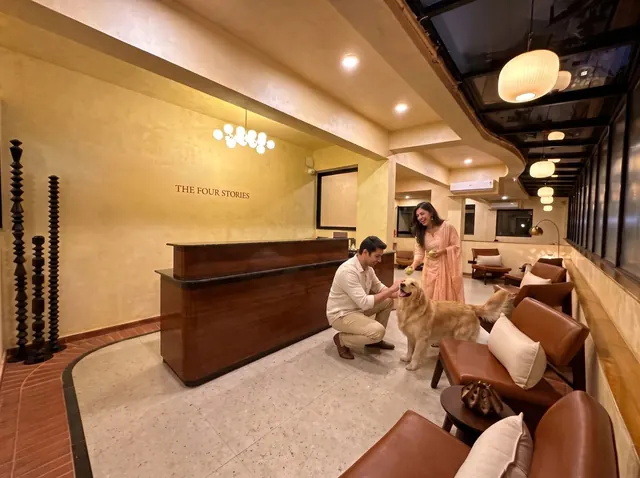 Guests with their dog at the reception desk of a pet-friendly hotel in Udaipur