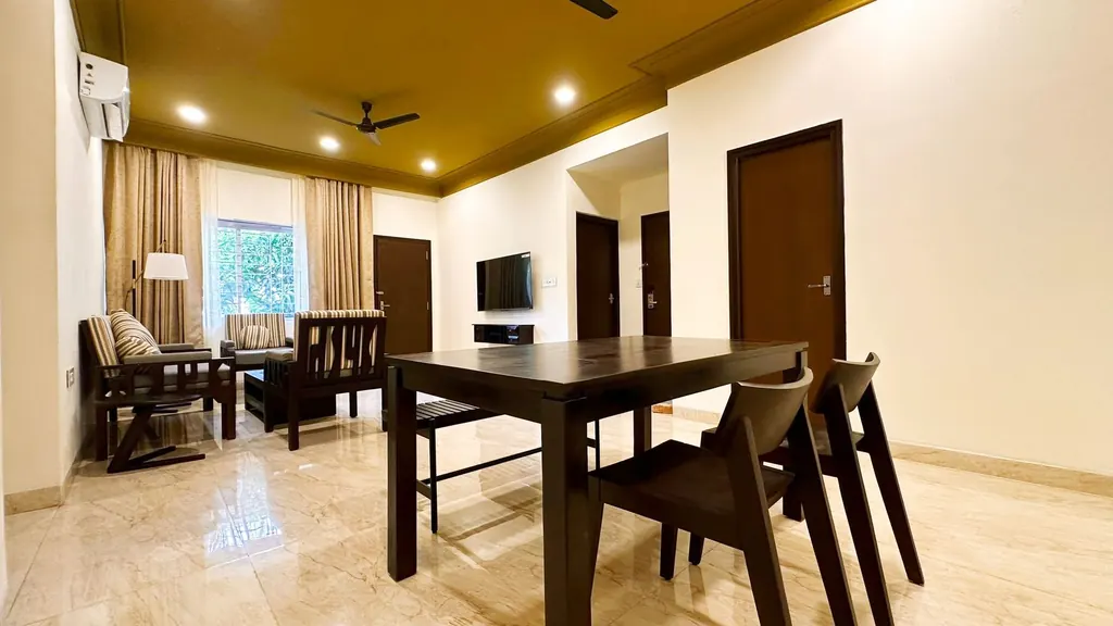 Superior 2 BHK Suite living lounge and dining table with doors to the bedrooms